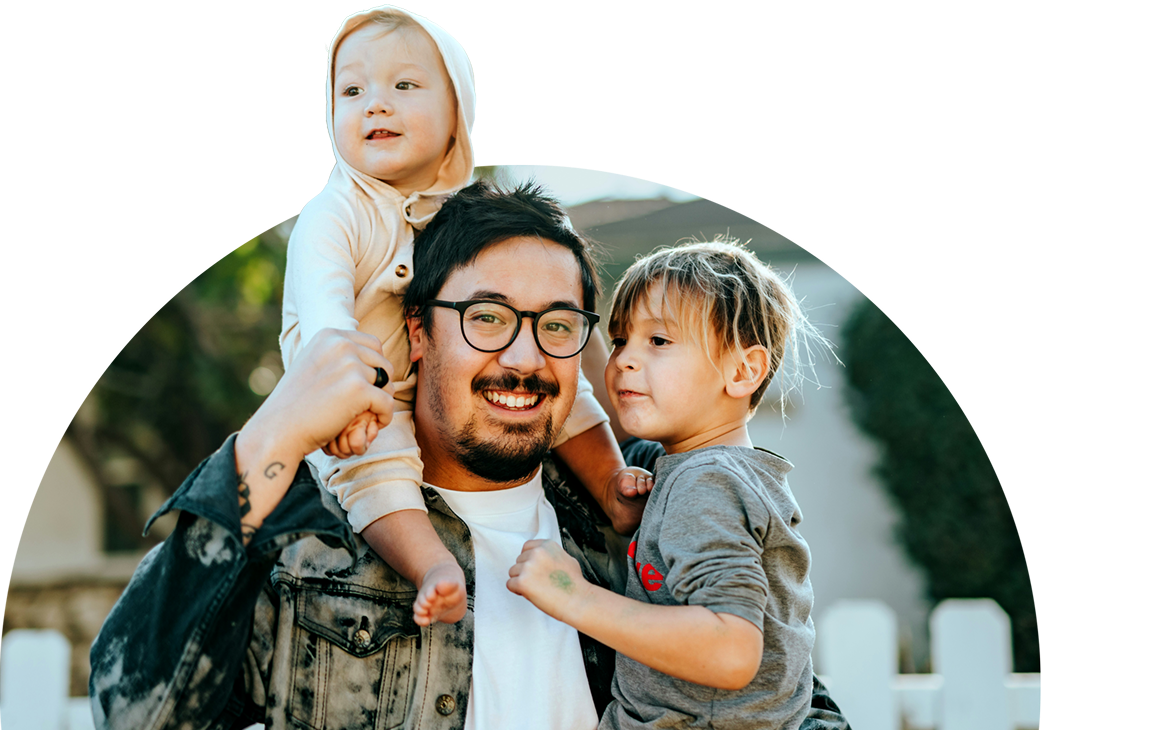 Young parent holding their two young children