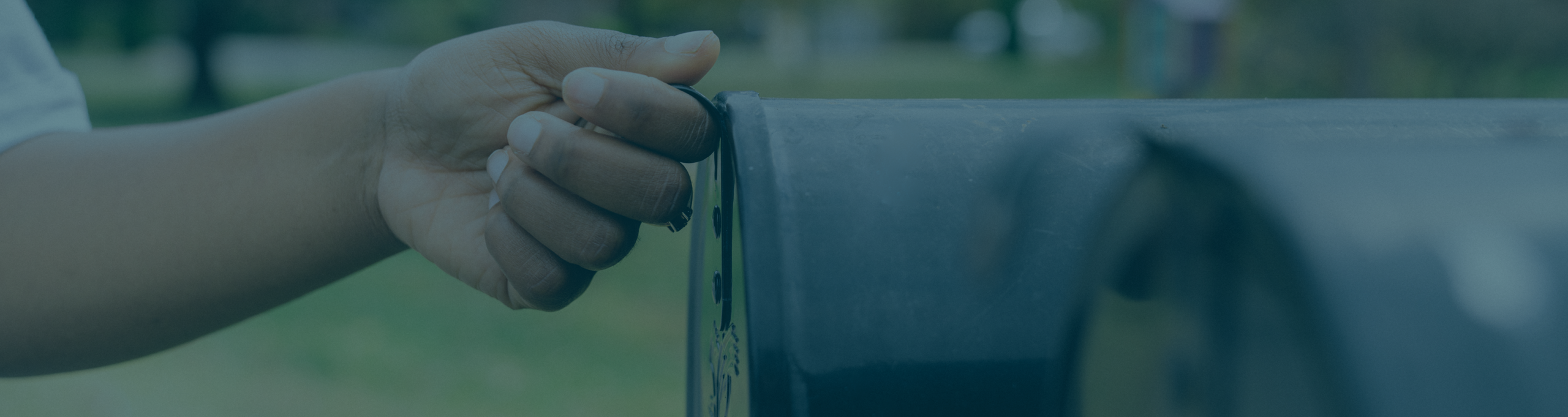 A hand opening a mailbox, representing utility marketing